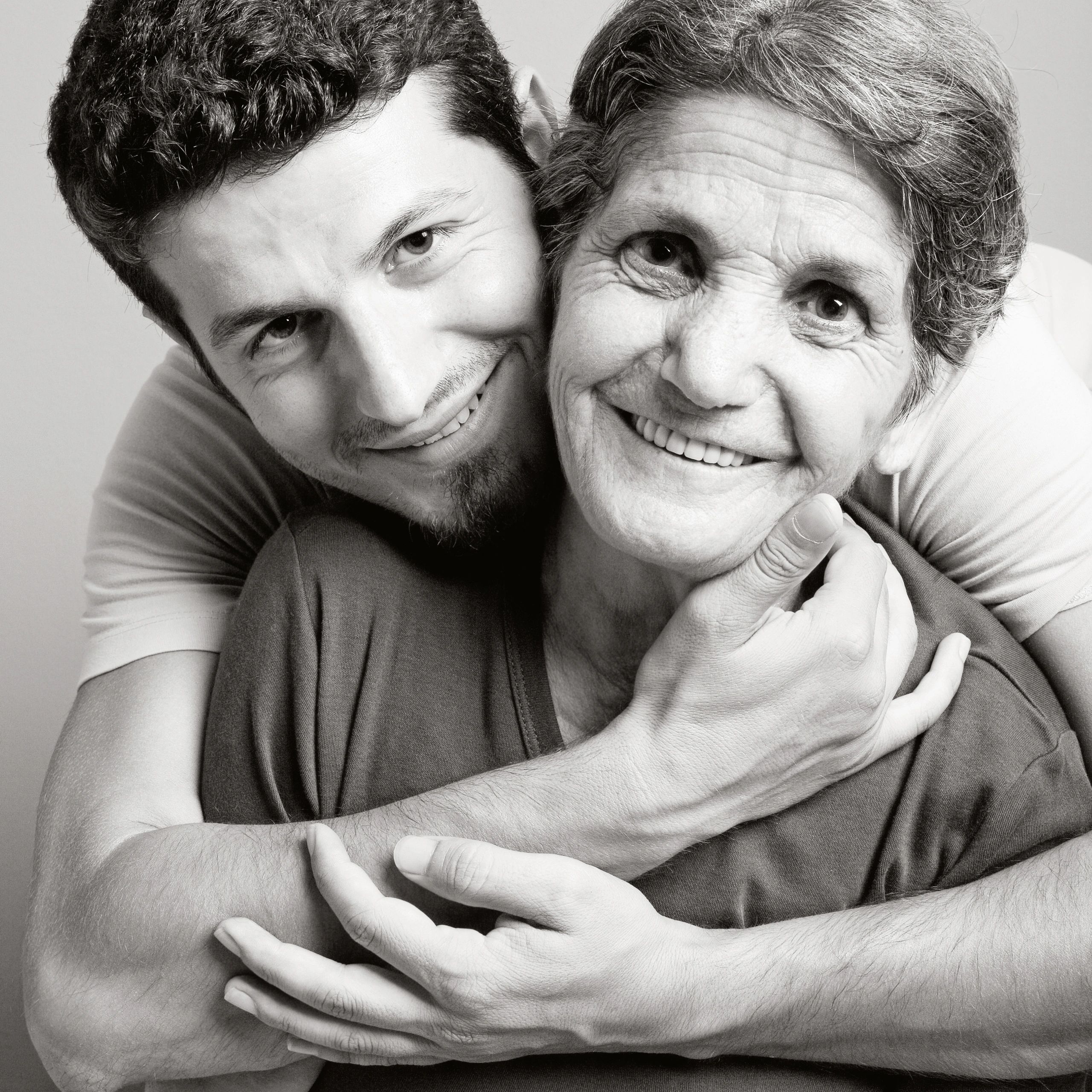 Portrait of mother and adult son smiling