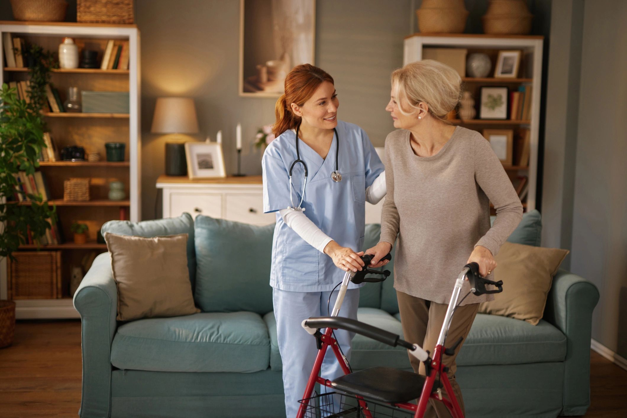 Caregiver assisting an older adult using a walker at home